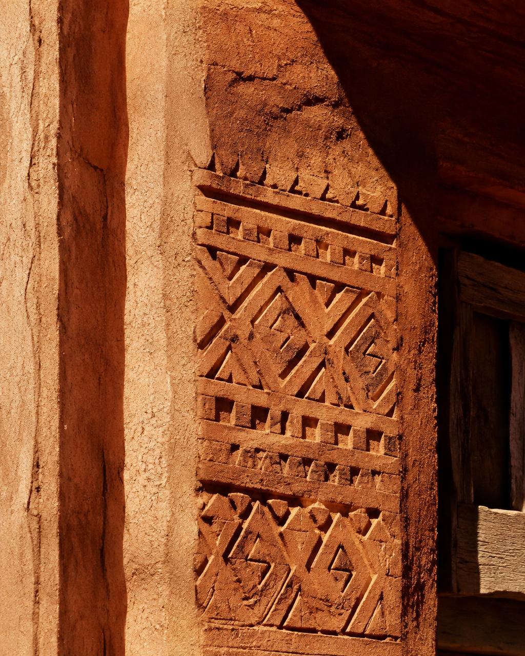 Illustration of geometric patterns on an earthen wall